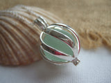 swirl cage locket with sea glass marble